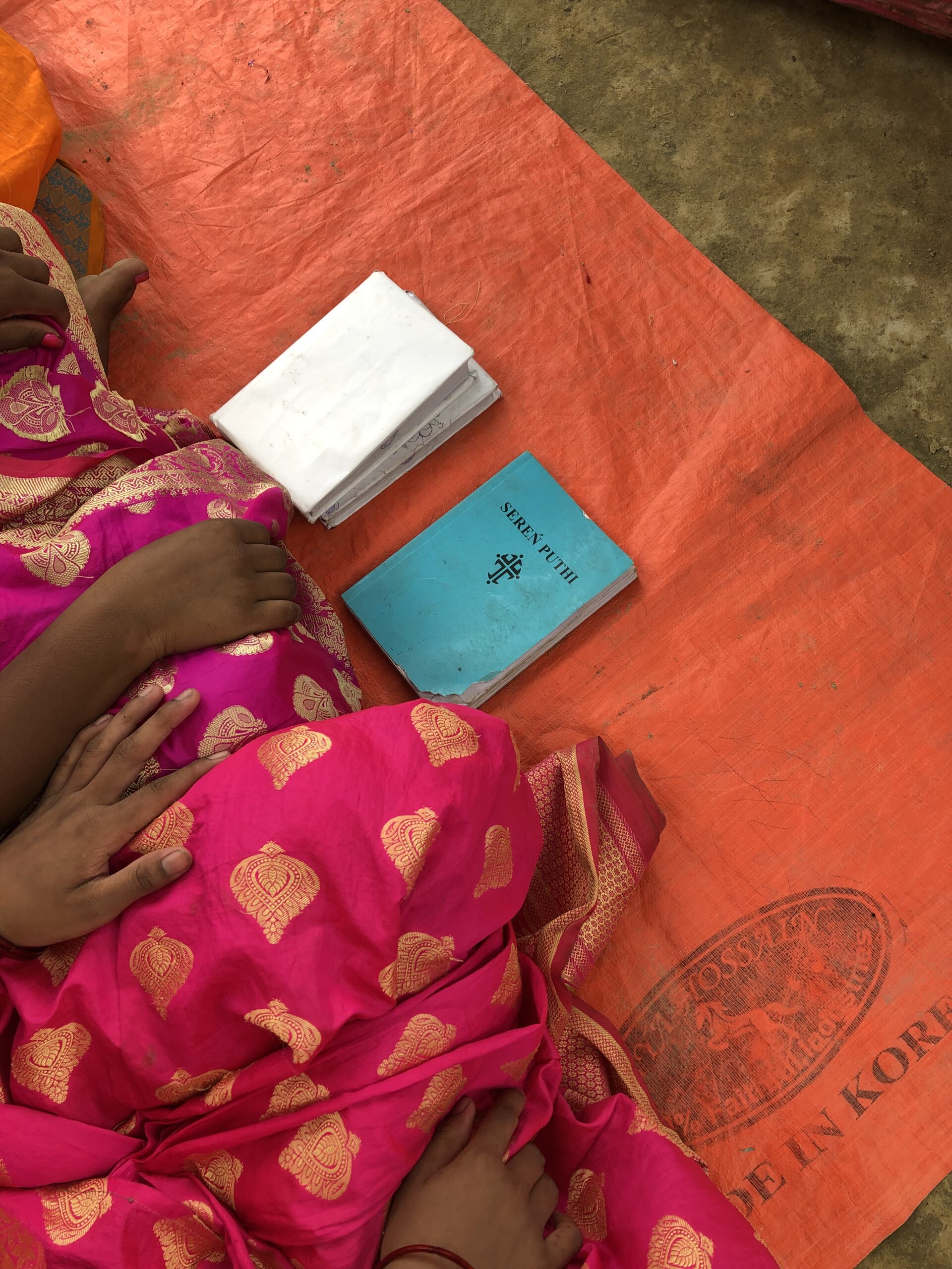 Two items newly baptized believers receive - a Bible and Hymn book in their own language