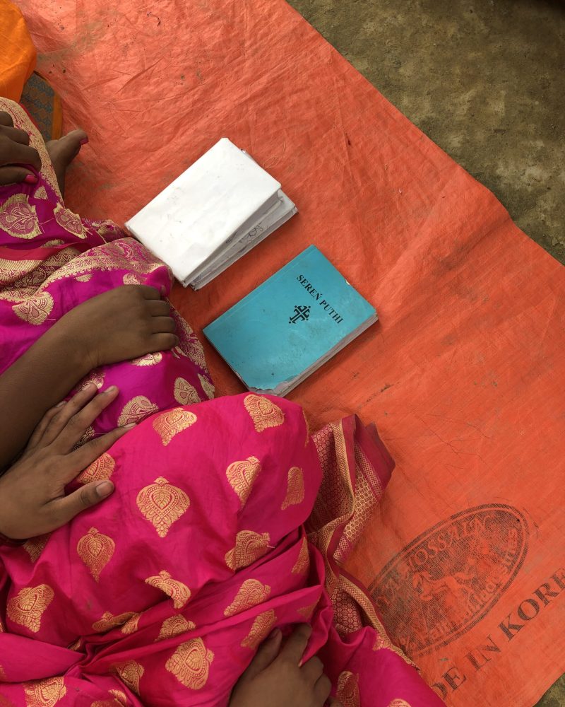 Two items newly baptized believers receive - a Bible and Hymn book in their own language